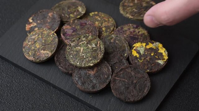 Organic Chinese green pu-erh tea with various herbs in round bricks. Chinese pu-erh tea as a background for your design