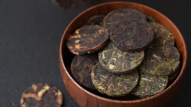 Organic Chinese green pu-erh tea with various herbs in round bricks. Chinese pu-erh tea as a background for your design