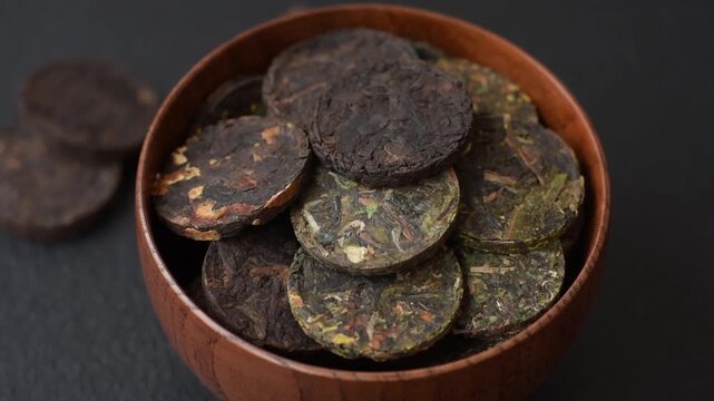 Organic Chinese green pu-erh tea with various herbs in round bricks. Chinese pu-erh tea as a background for your design