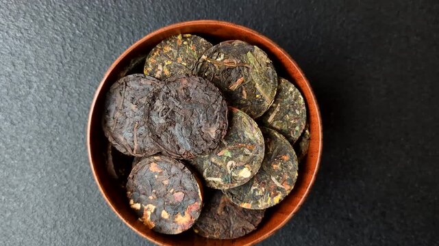 Organic Chinese green pu-erh tea with various herbs in round bricks. Chinese pu-erh tea as a background for your design