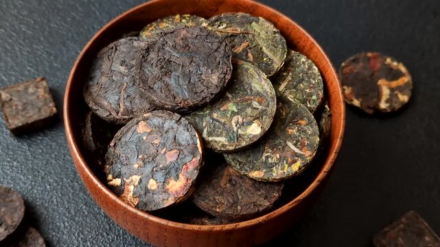 Organic Chinese green pu-erh tea with various herbs in round bricks. Chinese pu-erh tea as a background for your design