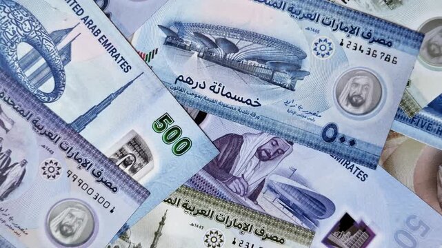 United Arab Emirates cash, paper dirhams, and coins for exchange and financial transactions. UAE currency as a background for your design