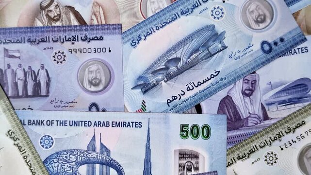 United Arab Emirates cash, paper dirhams, and coins for exchange and financial transactions. UAE currency as a background for your design