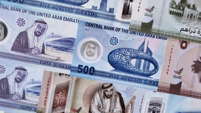 United Arab Emirates cash, paper dirhams, and coins for exchange and financial transactions. UAE currency as a background for your design