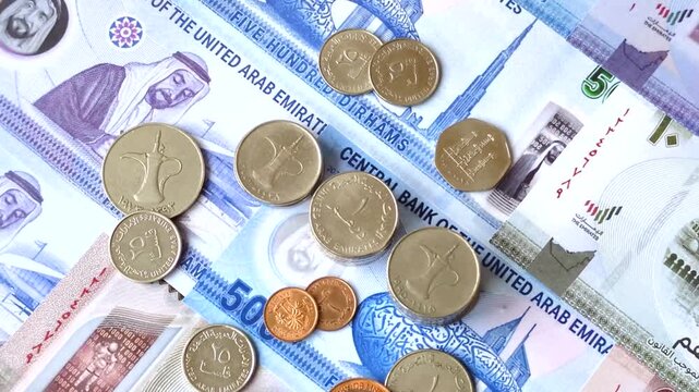 United Arab Emirates cash, paper dirhams, and coins for exchange and financial transactions. UAE currency as a background for your design