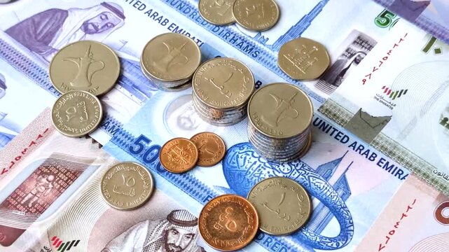 United Arab Emirates cash, paper dirhams, and coins for exchange and financial transactions. UAE currency as a background for your design