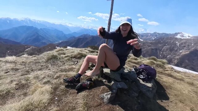 Massa del turlo, valsesia, valle strona, Italy - April: a girl wrings out her socks wet from the snow