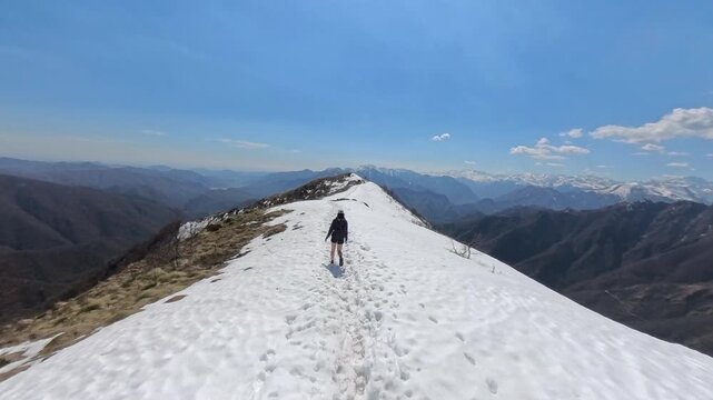 Woman hiking to the top of the mountain of Massa del turlo, valsesia, valle strona, Italy
