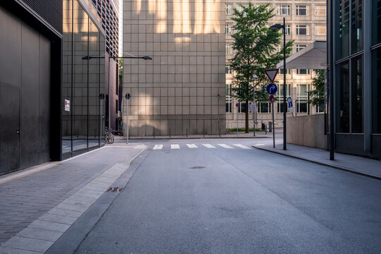 Shadow across an empty modern urban alley street with architecture and pavement perspective shaping calm wayfinding cues and minimal city direction