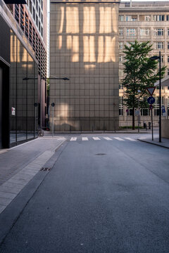 Symmetry in a modern urban alley street with empty pavement perspective and quiet architecture forms supporting wayfinding and minimal city orientation
