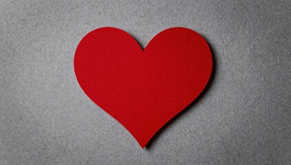 Obraz premium Vibrant red heart cut out on a gray background for valentine's day