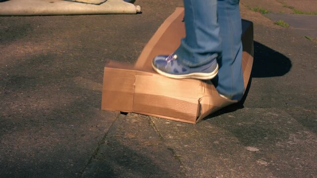 Jumping on cardboard box to squash