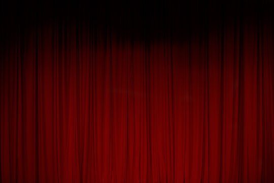 Red curtain at the theater during a show before the performance starts in the evening
