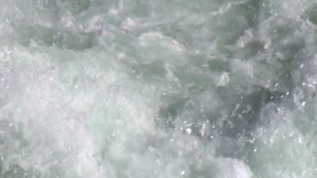 The swift river churns and foams. White water rushes powerfully downstream during spring snow melt. The cascade is mesmerizing and beautiful.