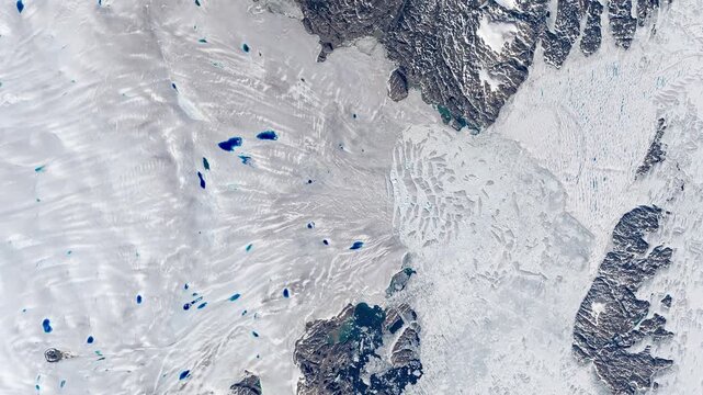 Panoramic shot on glacier flowing into sea, cracking in pieces making icebergs. Camera is moving forward. Animation based on image by NASA
