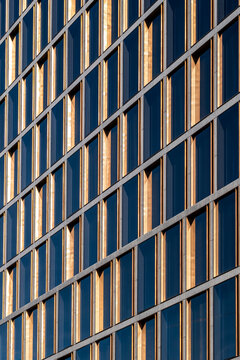 Geometric grid windows on modern glass architecture facade with strong lines and repeating pattern delivering clean detail for urban office design