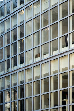 Urban modern office architecture with glass facade and geometric grid windows emphasizing repetition and clean building structure detail for business