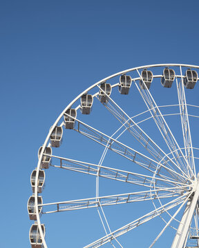 Large observation wheel under clear blue sky with copy space, modern travel and leisure concept