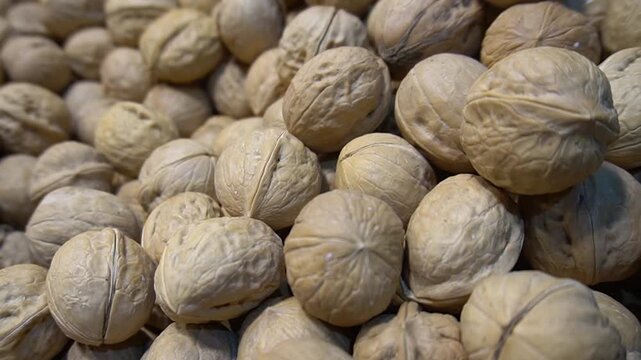Macro close-up of walnuts highlighting natural shell texture and earthy tones, organic food concept