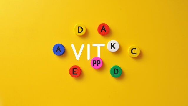 VIT lettering with colorful vitamin pills, minimal nutrition and supplement concept