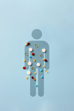 Human body silhouette filled with pills, medication and healthcare concept