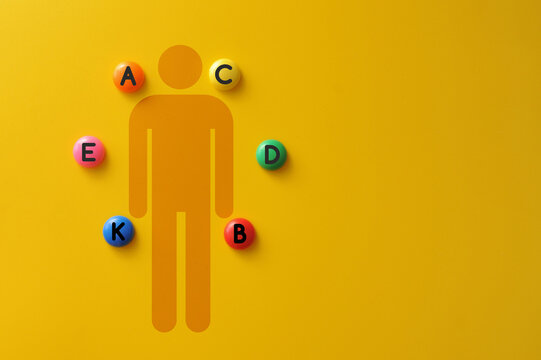 Human body silhouette surrounded by vitamin icons, balanced nutrition concept