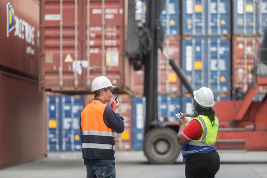 Workers coordinating container handling at port