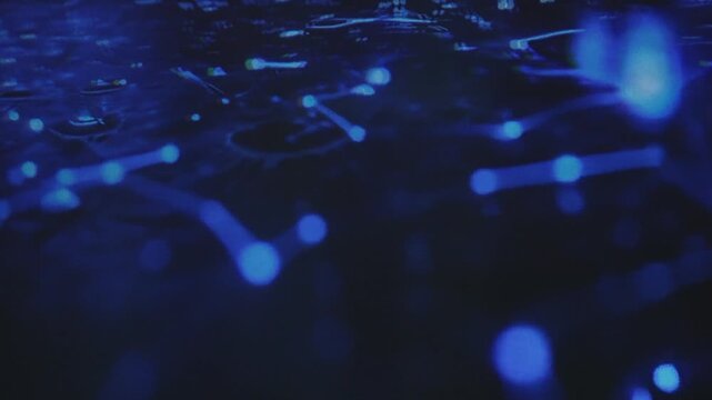 A professional man interacts with a high-tech circular data interface on a large digital screen, featuring graphs and data elements in a glowing blue theme.