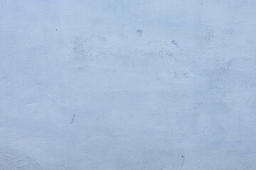 Fototapeta premium Minimalist light blue plastered concrete wall texture background with subtle grain and clean architectural surface detail