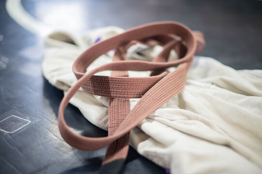 Selective focus background image martial arts kimono Gi and belt, traditional martial arts, isolated subject, copy space image, brown belt, jiujitsu martial arts rank. Martial arts rank copy space bac