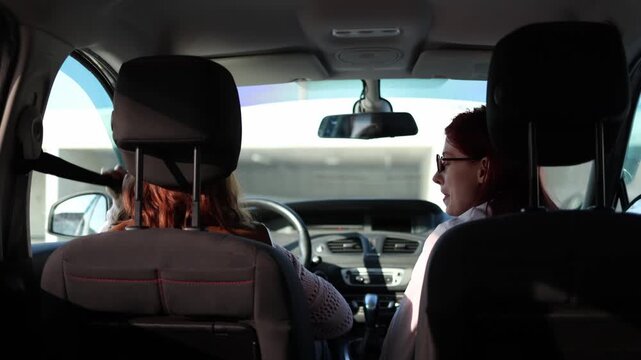 Driving instructor observes student preparing to start driving checking seatbelt and initial actions while learner begins lesson inside car focusing on safety routine before moving