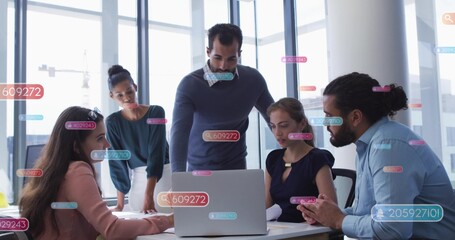 Five business coworkers leaning and discussing around silver laptop in boardroom with data overlays © vectorfusionart