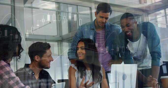 Analyzing market charts, five coworkers in office wear clustered around monitor with coffee cup