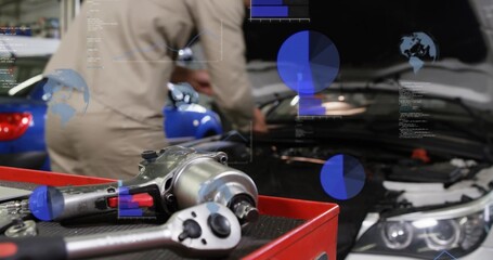 Fototapeta premium Showing red tray with impact wrench in shop, coverall mechanic leaning into engine with AR overlays