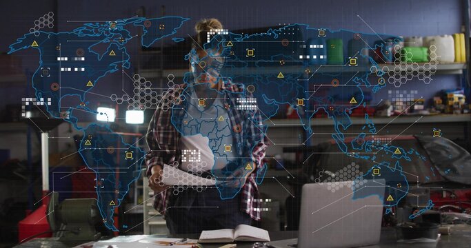 Reviewing docs, female tech in plaid, dark pants checking laptop on garage bench, hologram overlay