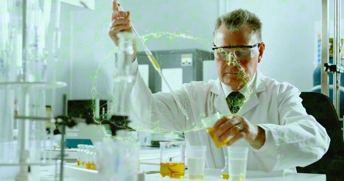 Handling scientist pipetting yellow liquid at lab bench in lab coat, tie, goggles, neon-green glow