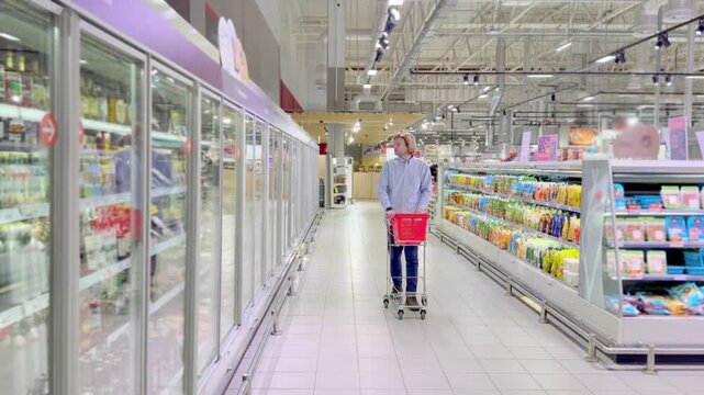 Choosing food from shelf at the supermarket,vegetables in the grocery section, Grocery stores 