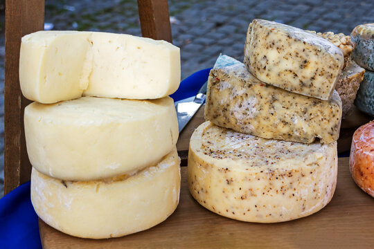 Traditional organic cheese selection sold outside on local market stall