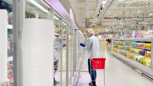 Choosing food from shelf at the supermarket,vegetables in the grocery section, Grocery stores 