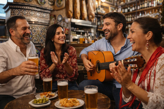 Friends Playing Flamenco Guitar in Traditional Spanish Bar in Seville