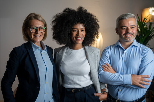 Successful business team standing together in a boardroom