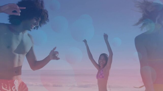 Vertical video: Dancing after camera shift, friends raising arms at beach in swimwear, pastel tints