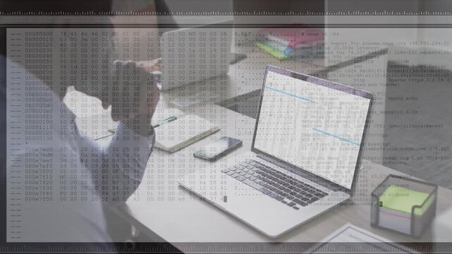 Mature man at desk studying spreadsheet while laptop streaming log overlay fading in for monitoring