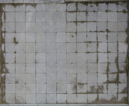 Grimy tiled floor with mildew stains in outdoor setting