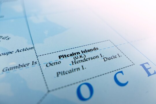 Map of Pitcairn with flare from top right corner. Selective focus on label, close-up view