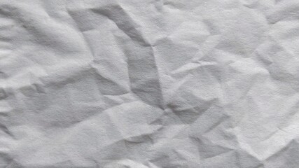 Fototapeta premium White crumpled paper texture background. Abstract wrinkled paper surface with shadows.