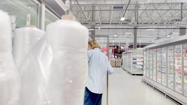 Choosing food from shelf at the supermarket,vegetables in the grocery section, Grocery stores 