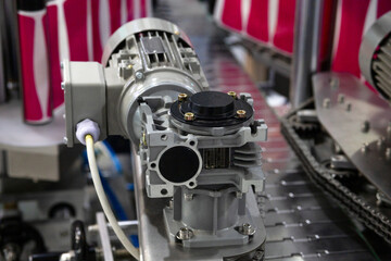 Fototapeta premium Labeling machine for containers. Packaging machine in production.