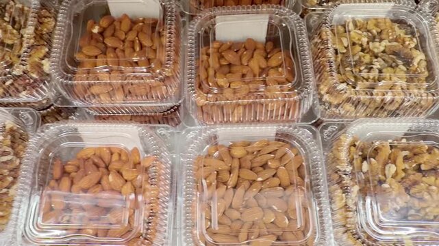 Choosing a variety of nuts at the supermarket
