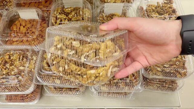 Choosing a variety of nuts at the supermarket